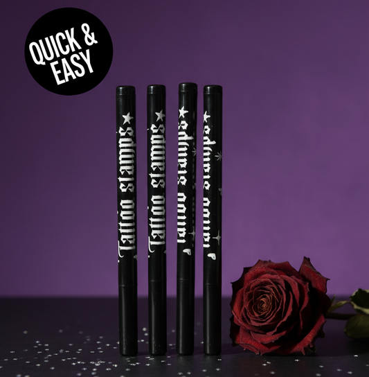 Four black tattoo pencils with white text on a purple background, accompanied by a red rose.